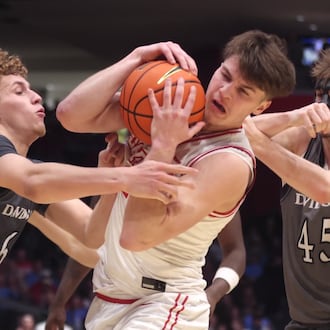 Dayton's Jordan Derkack tries to hold onto the ball against Davidson on Sunday, Feb. 15, 2026, at UD Arena. David Jablonski/Staff