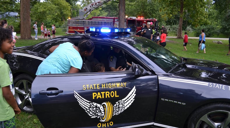 Children take a look inside an Ohio State Patrol vehicle during the National Night Out event. FILE