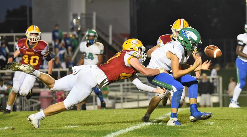 Fenwick’s Ben Gustely (47) and Joe Perrotti (43) apply the pressure as Chaminade Julienne quarterback Luke Chandler fumbles the ball during Friday night’s game at Krusling Field in Middletown. Fenwick posted a 34-19 win. CONTRIBUTED PHOTO BY ANGIE MOHRHAUS