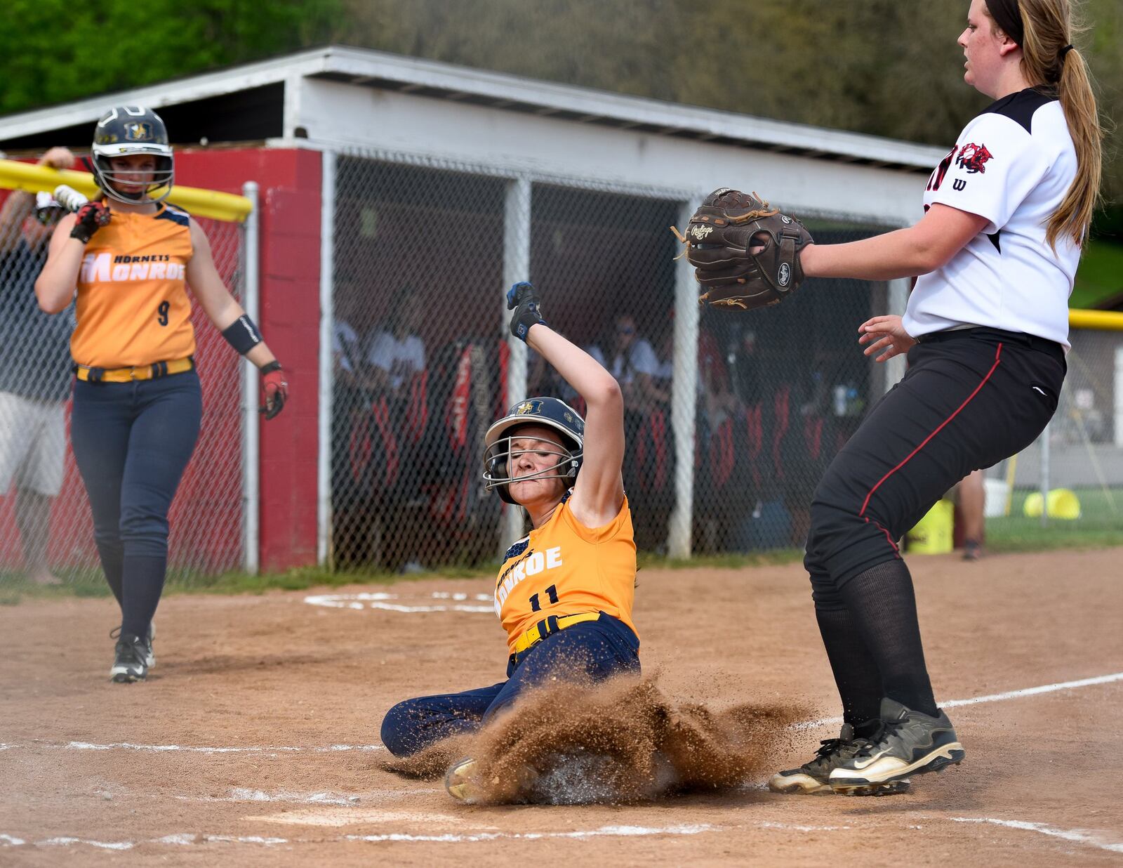 Monroe’s Faith Hensley slides into home plate for a run while Franklin pitcher Emily Temple waits for the ball during their game on May 5, 2015, at Franklin Community Park. Hensley’s Hornets won 13-10. NICK GRAHAM/STAFF