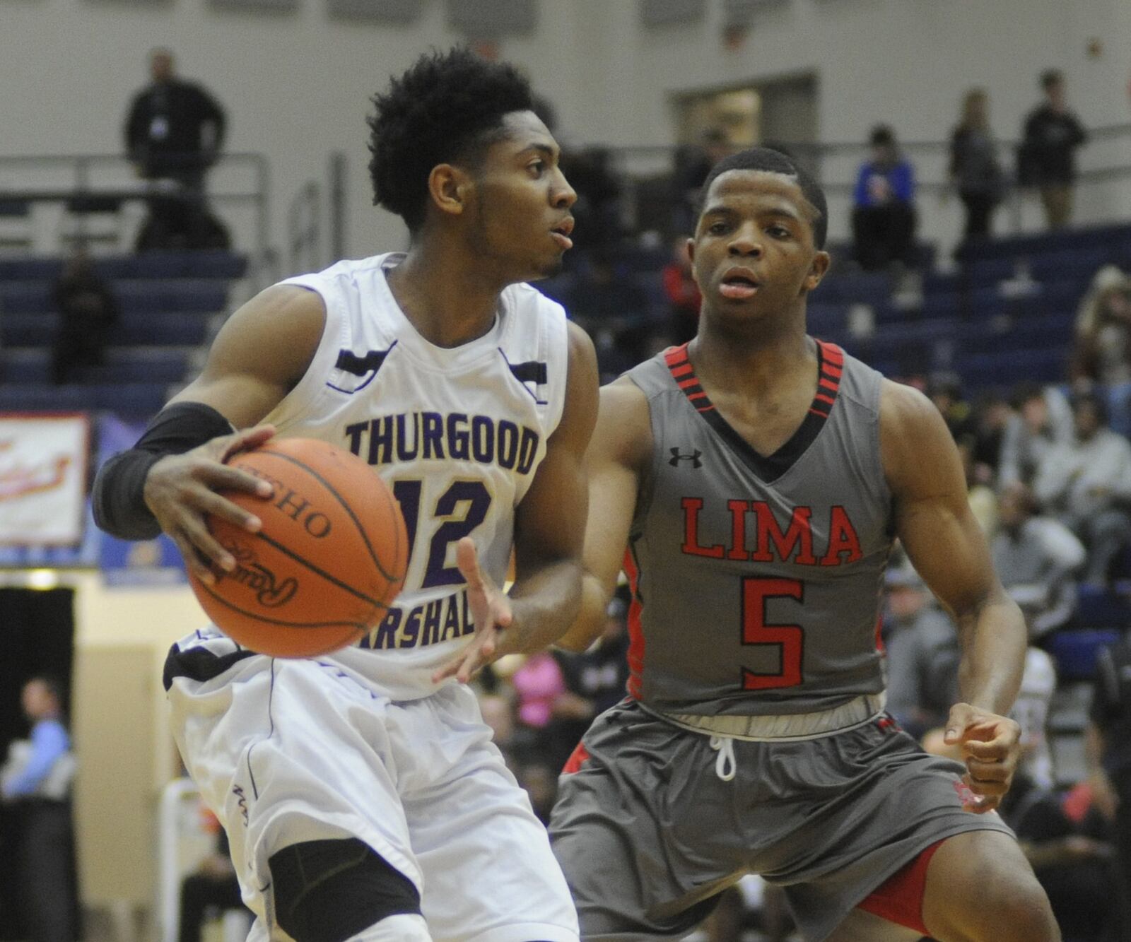 Thurgood Marshall senior Darnell Hoskins Jr. (with ball) is confronted by Xavier Simpson. Lima Senior defeated Thurgood 83-66 in the Premier Health Flyin’ to the Hoop at Fairmont’s Trent Arena in Kettering on Monday, Jan. 18, 2016. Simpson would be named the 2016 Ohio Mr. Basketball and was a freshman at the University of Michigan this past season. MARC PENDLETON / STAFF