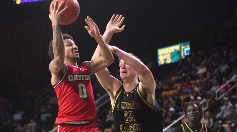 Dayton's Javon Bennett scores at the halftime buzzer against George Mason on Wednesday, Feb. 18, 2026, at EagleBank Arena in Fairfax, Va. David Jablonski/Staff