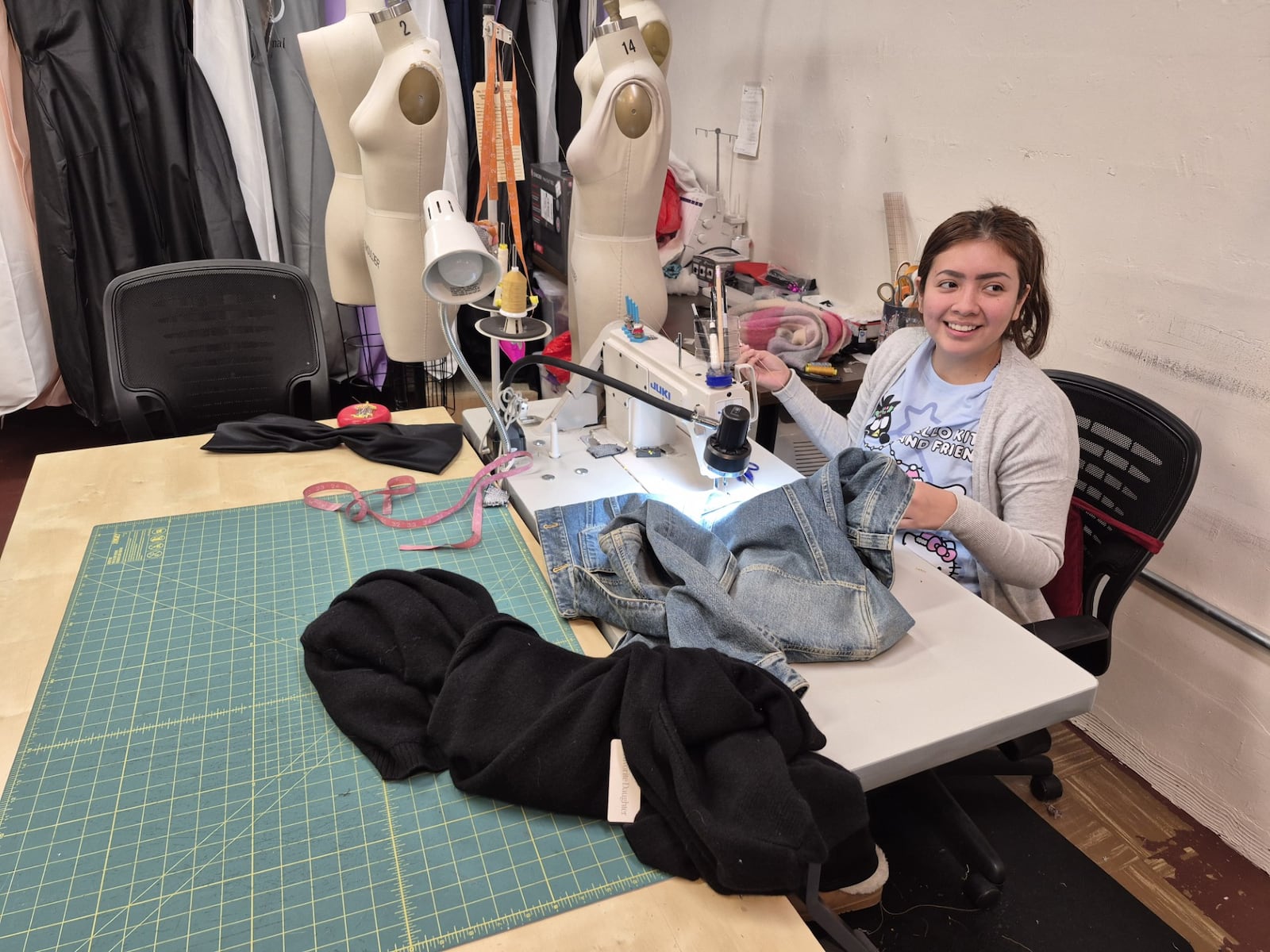 Seamstress Ashley Barbecho said she is excited to have windows when Bahar & Reza relocates to Centerville from Oakwood. MICHAEL KURTZ / STAFF