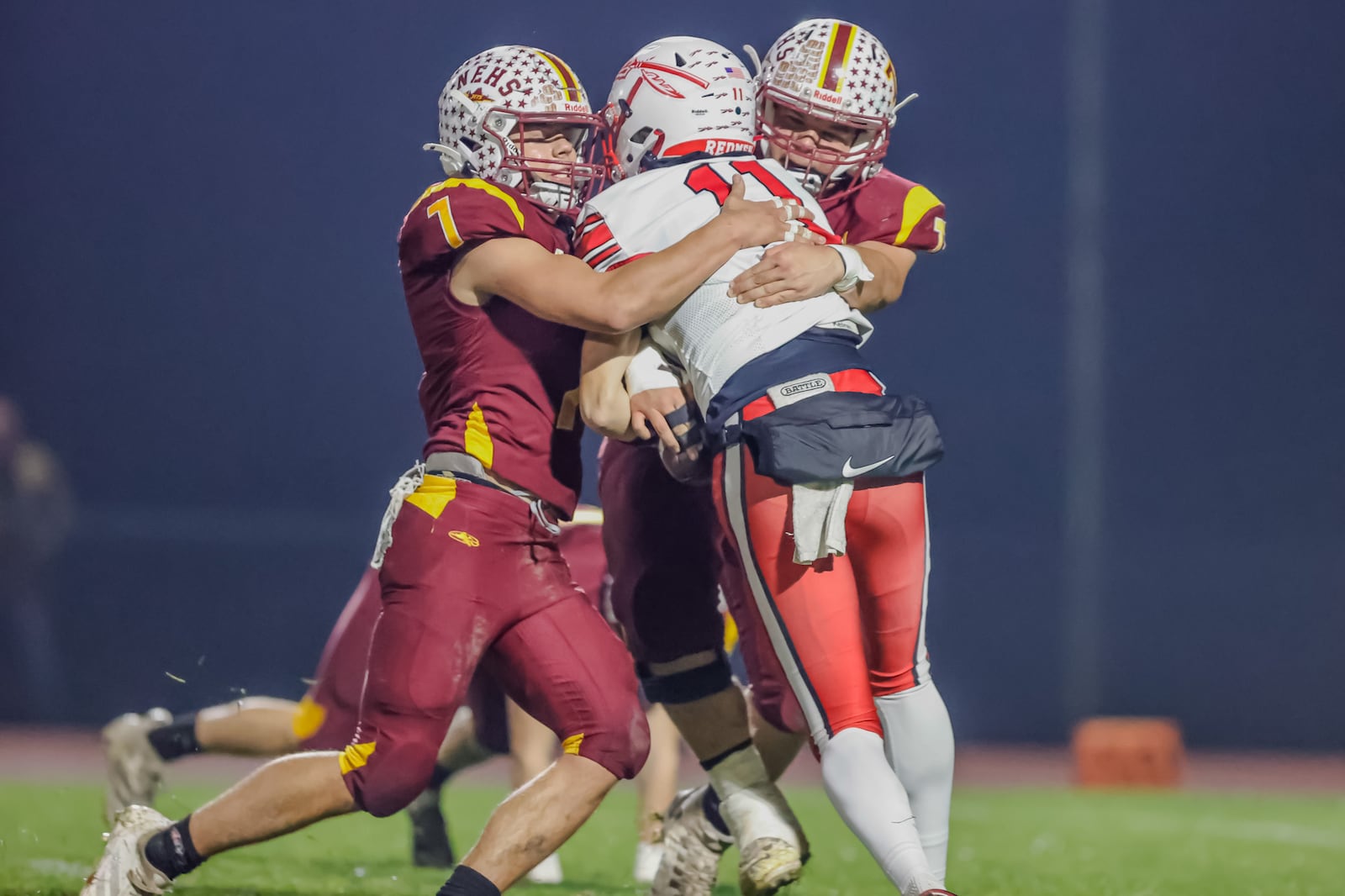 Northeastern High School seniors Jackson Jones and Steven Roddy tackle Ironton Rock Hill freshman quarterback Jarrod Bridges during their 59-0 victory in a Division VI, Region 24 quarterfinal game on Friday, Nov. 7 at Conover Stadium in Springfield. MICHAEL COOPER / STAFF PHOTO