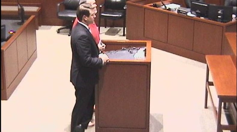 Michael Schneider, 55, of Clermont County, stands with his lawyer, William Oswall Jr., during his sentencing in Warren County.
