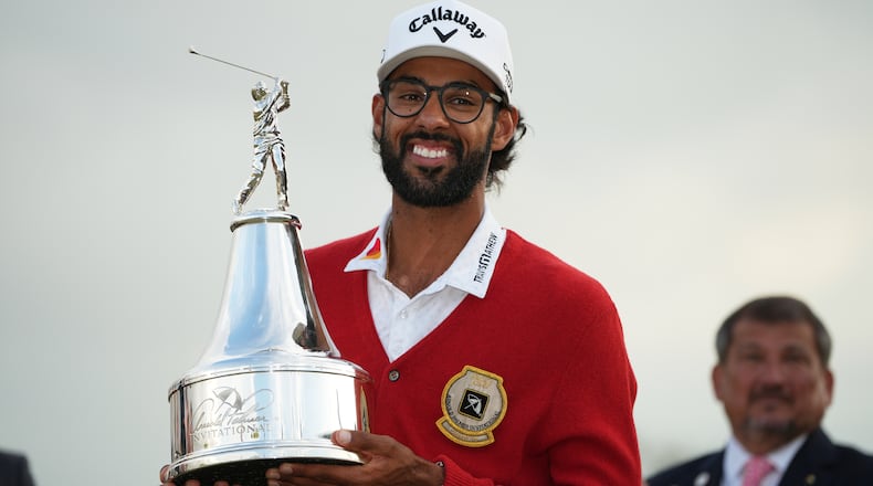 Akshay Bhatia holds the championship trophy after winning the Arnold Palmer Invitational at Bay Hill golf tournament Sunday, March 8, 2026, in Orlando, Fla. (AP Photo/Matt Slocum)