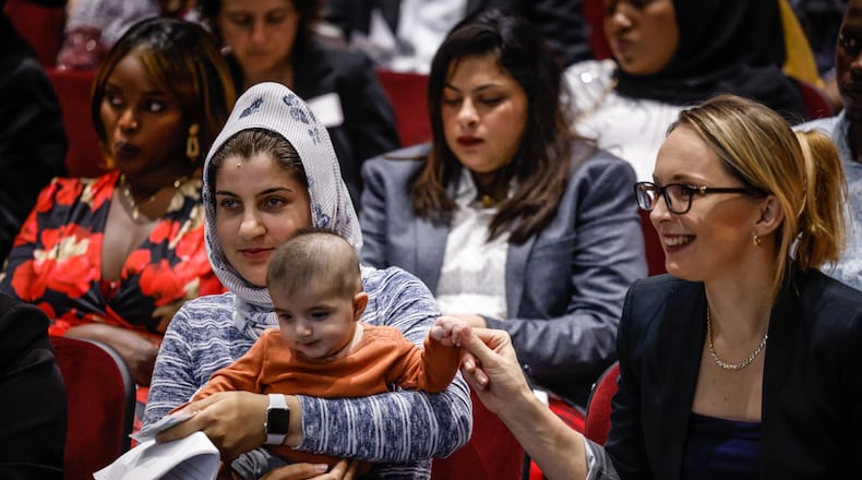 Whid Reza and her daughter, Safda, left, and Maria Kasperek sit with other naturalization candidates before the ceremony at the Montgomery County Board of Election on Tuesday Sept. 20, 2022. JIM NOELKER/STAFF
