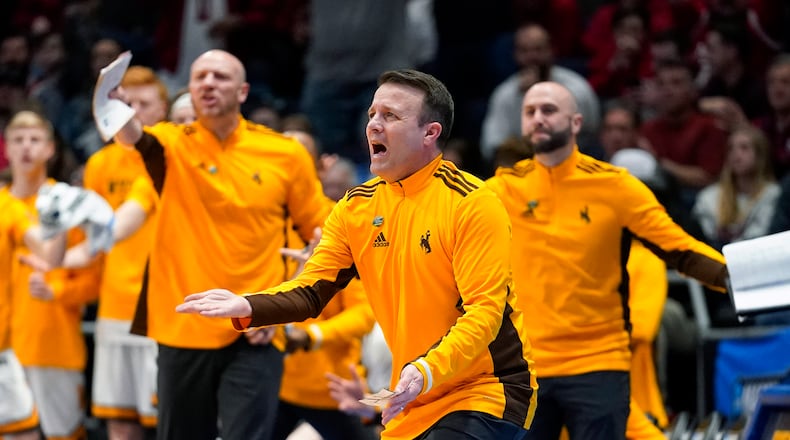 Wyoming hcoach Jeff Linder, center, reacts to a technical foul during the first half of the team's First Four game against Indiana in the NCAA men's college basketball tournament Tuesday, March 15, 2022, in Dayton, Ohio. (AP Photo/Jeff Dean)