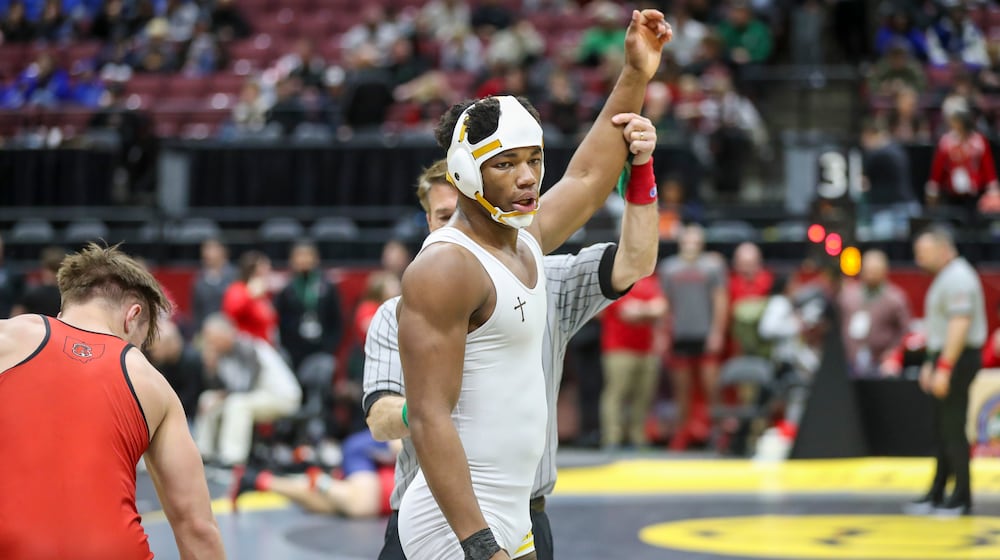 Alter High School junior Rod Owens raises his arm in the air after winning a match at the Ohio High School Athletic Association state wrestling championships on Friday, March 7 at the Schottenstein Center in Columbus. Owens won the Division II state title in the 175 pound weight class. Dave Thompson/CONTRIBUTED