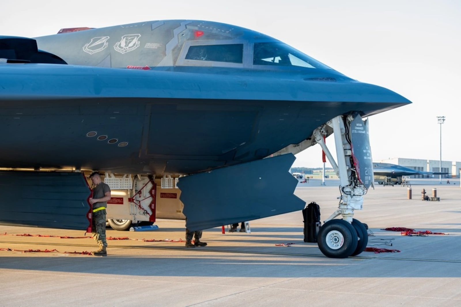 U.S. Airmen from the 393d Bomber Generation Squadron inspect and secure protective covering on the B-2 Spirit stealth bomber at Whiteman Air Force Base, Mo., July 25, 2024. (U.S. Air Force photo by Airman 1st Class Bryce Moore)