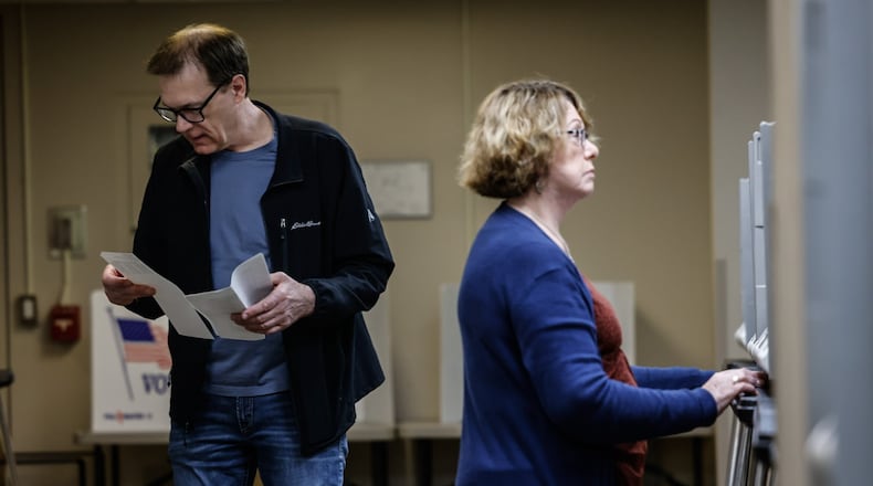 Larry Gache and Betty White  vote early at the Montgomery County Board of Elections Thursday March 14, 2024. JIM NOELKER/STAFF
