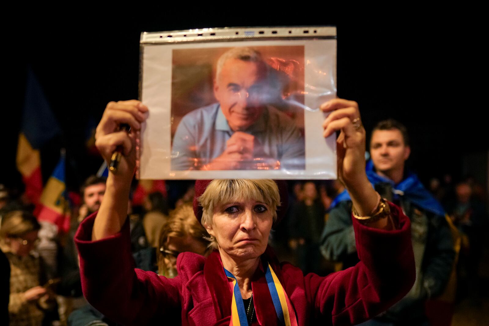 FILE - A woman holds a portrait of Calin Georgescu during a protest after Romania's Constitutional Court upheld a ban on his candidacy in the presidential election rerun, in Bucharest, Romania, Tuesday, March 11, 2025. (AP Photo/Vadim Ghirda. File)