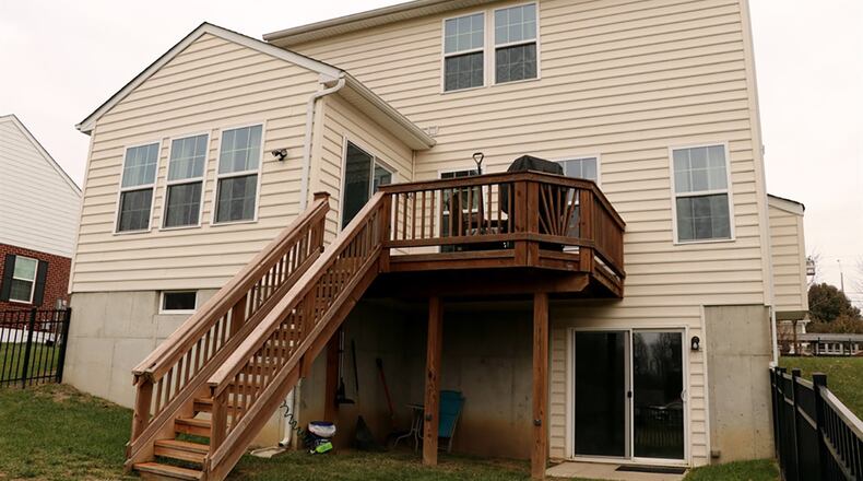 A cathedral ceiling peaks over the morning room, which has several windows that look out over the back yard. Patio doors open to the balcony deck, which has steps that lead to the fenced back yard.