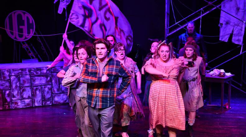 Garrett Young (center as Bobby Strong) and the cast of TheatreLab Dayton's production of "Urinetown." PHOTO BY MACKENSIE KING