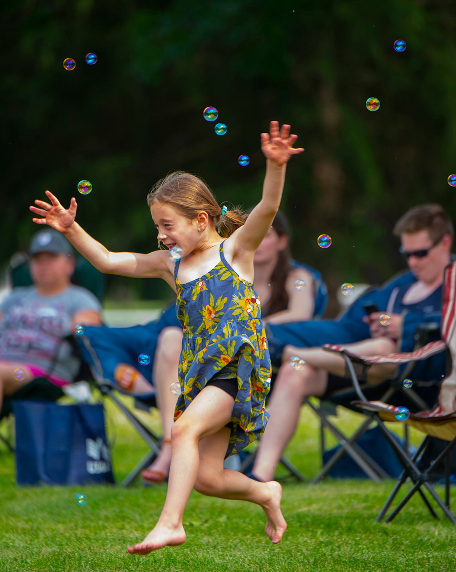 Alexandra Burger, 6, daughter of Col. Paul Burger, dances and chases bubbles June 24 at a block party sponsored by the 88th Force Support Squadron at Turtle Pond in the Brick Quarters historic district at Wright-Patterson Air Force Base. U.S. AIR FORCE PHOTO/R.J. ORIEZ