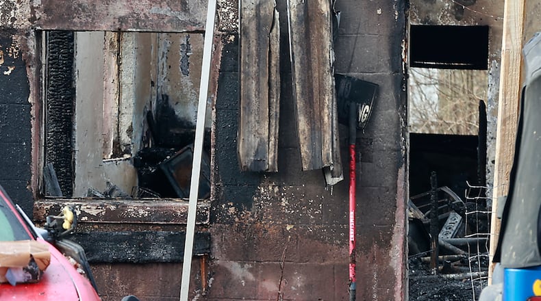 The charred remains of a house on Cherry Drive where several dogs were killed in a fire Sunday night. BILL LACKEY/STAFF