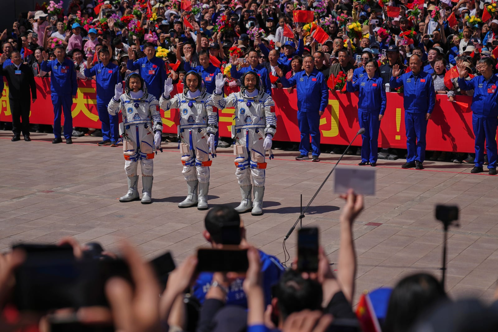 Chinese astronauts for the Shenzhou 20 mission, from right, Chen Zhongrui, Chen Dong and Wang Jie wave as they attend a send-off ceremony for their manned space mission at the Jiuquan Satellite Launch Center in northwestern China, Thursday, April 24, 2025. (AP Photo/Andy Wong)