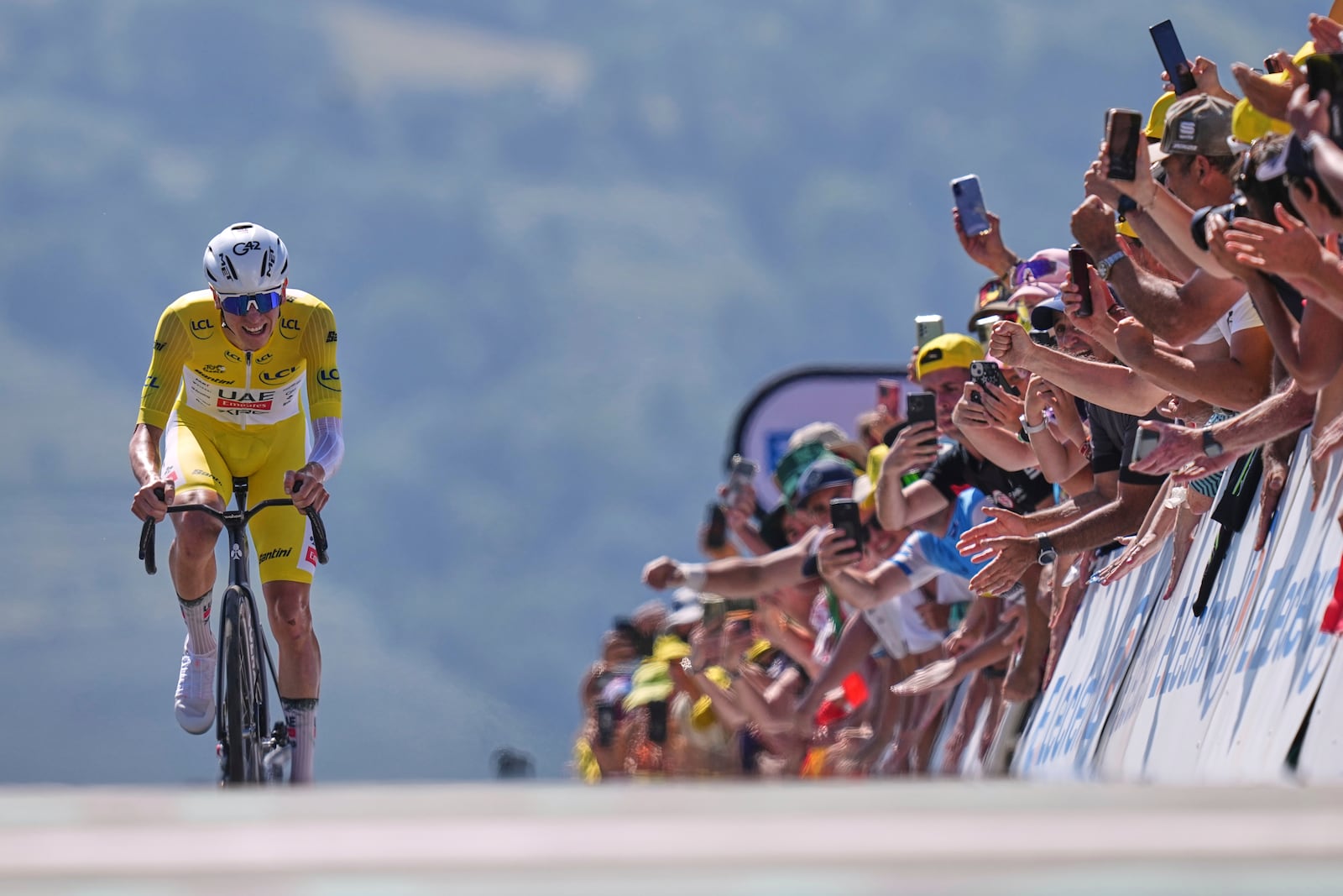 Slovenia's Tadej Pogacar, wearing the overall leader's yellow jersey, wins the thirteenth stage of the Tour de France cycling race, an individual time-trial over 10.5 kilometers (6.5 miles) in the Pyrenees mountains with start in Loudenvielle and finish in Peyragudes, France, Friday, July 18, 2025. (AP Photo/Thibault Camus)
