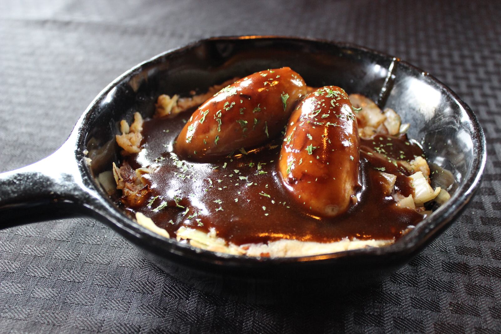 The Dublin Pub's St. James Bangers and Champ is  $13.99 and consists of sausages slow-cooked in Guinness, then seared and served on a bed of Champ (mashed potatoes, sautéed cabbage, applewood bacon, onion) and topped with Guinness gravy. ALLEGRA CZERWINSKI / STAFF PHOTO
