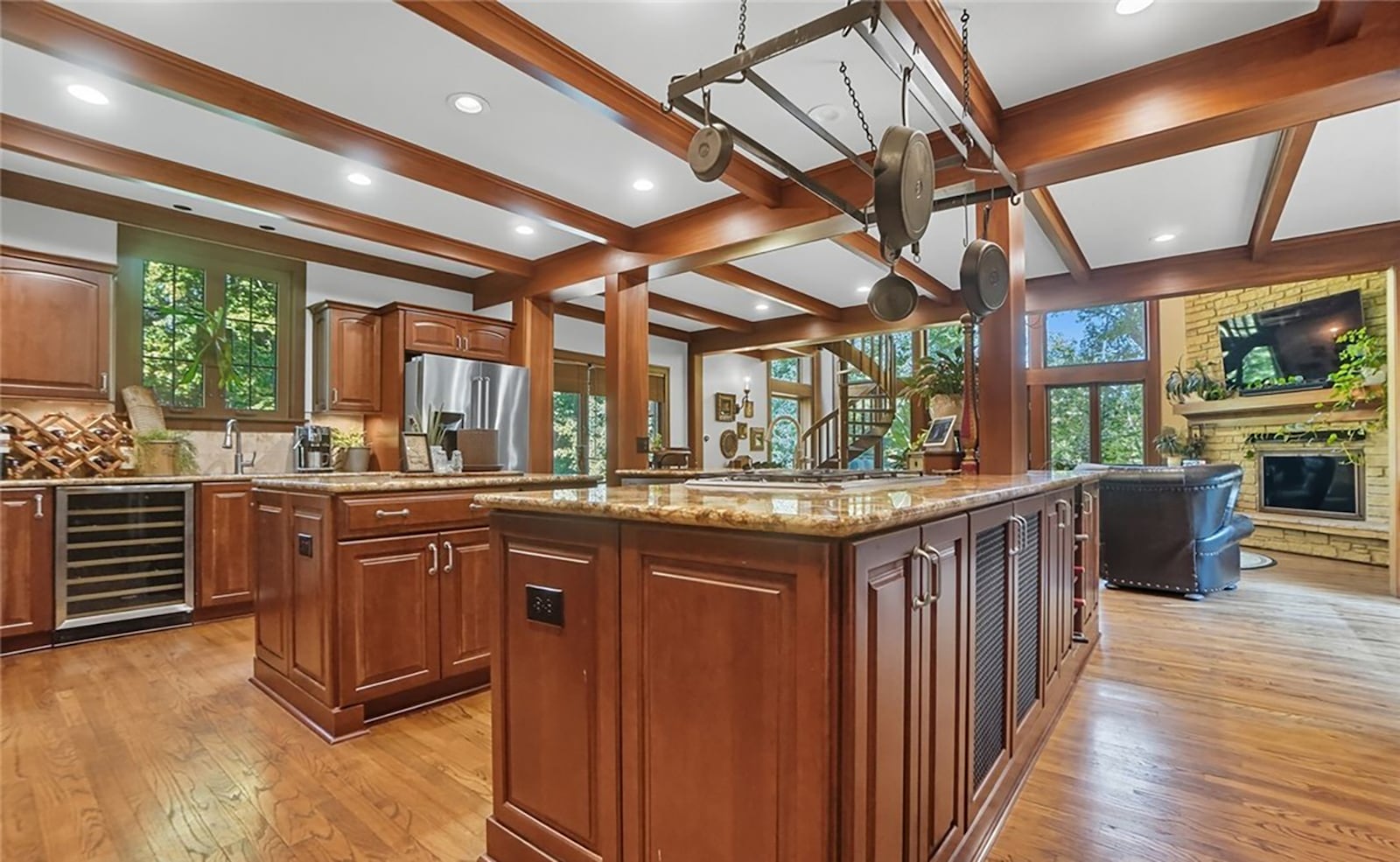 The completely updated kitchen features cherry cabinets, wood beamed ceiling, granite countertops and recessed lighting. All the appliances have been updated and include a gas cooktop, double ovens and a beverage cooler. CONTRIBUTED