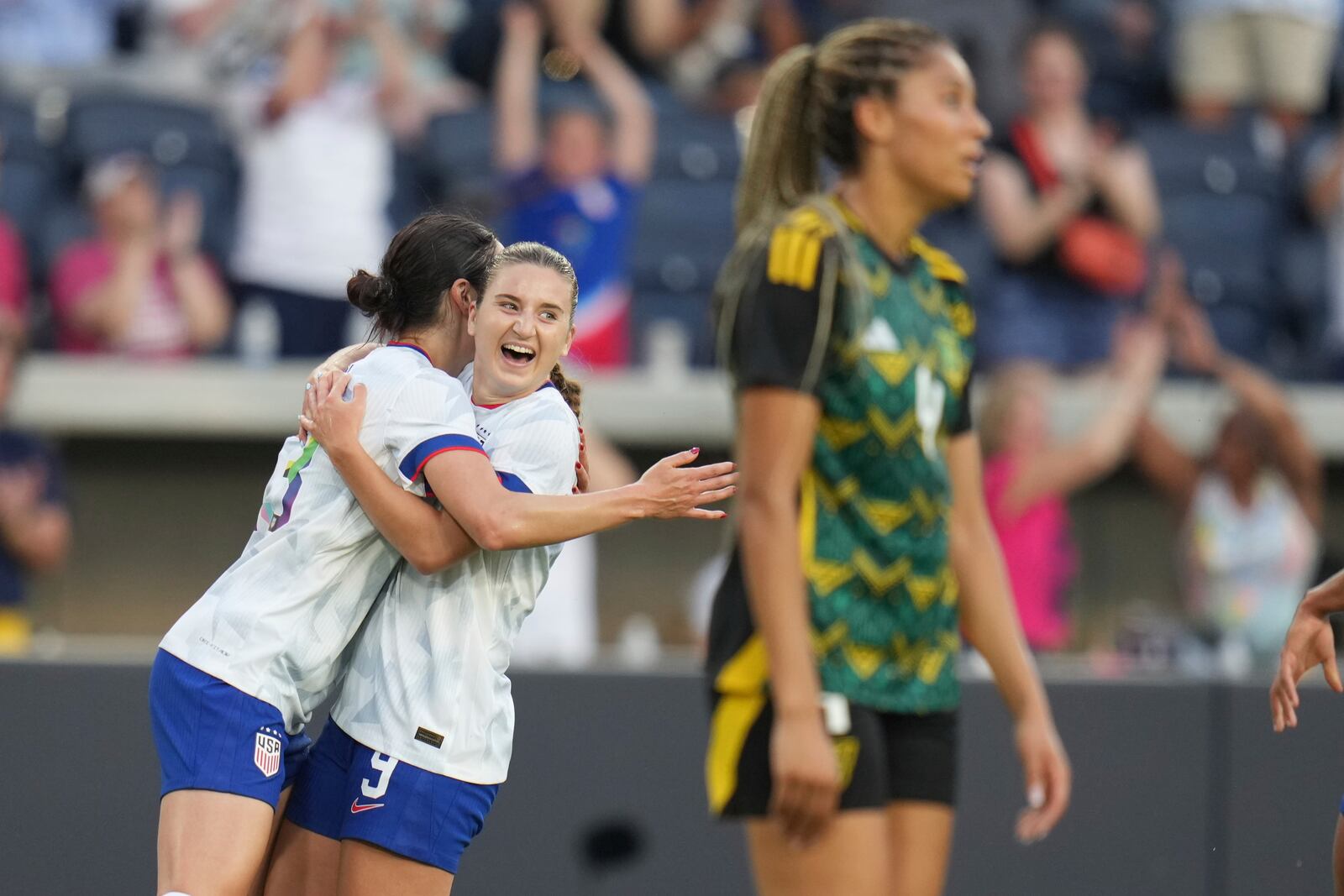 United States' Ally Sentnor is congratulated by teammate Emily Fox, left, after scoring as Jamaica's Chantelle Swaby, right, walks past during the first half of an international friendly soccer match Tuesday, June 3, 2025, in St. Louis. (AP Photo/Jeff Roberson)