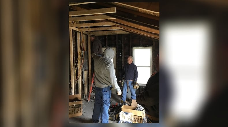 Volunteers including Miami County building inspectors work on the home of an elderly Troy woman. The inspectors volunteered their time to rewire the house. CONTRIBUTED