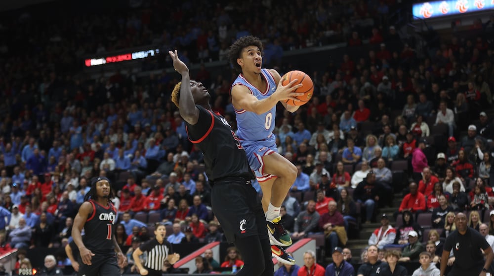 Dayton's Javon Bennett shoots against Cincinnati on Saturday, Dec. 16, 2023, at the Heritage Bank Center in Cincinnati. David Jablonski/Staff