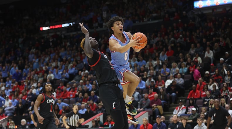 Dayton's Javon Bennett shoots against Cincinnati on Saturday, Dec. 16, 2023, at the Heritage Bank Center in Cincinnati. David Jablonski/Staff