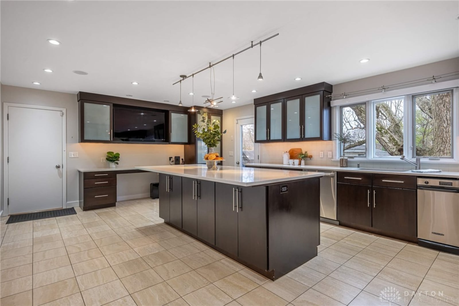 The kitchen has tile flooring, recessed lighting, wood cabinets, quartz countertops and an island. It also has a planning desk and upgraded professional quality appliances. CONTRIBUTED