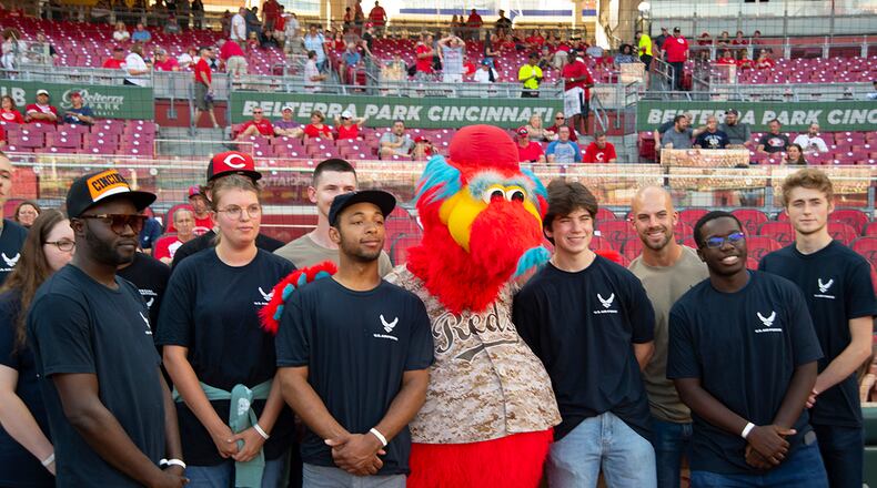 A group of Air Force recruits pose with the Cincinnati Reds mascot, Gapper, prior to a Reds-Rockies game Sept. 2. As part of the military appreciation night pregame activities, the recruits took the oath of enlistment on the field in Great American Ball Park. U.S. AIR FORCE PHOTO/R.J. ORIEZ