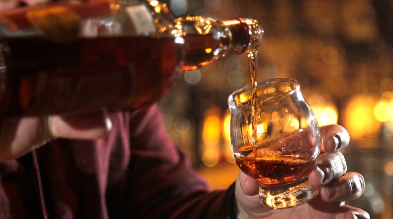 The Century Bar in downtown Dayton is known for a vast selection of bourbons and whiskeys. LISA POWELL / STAFF