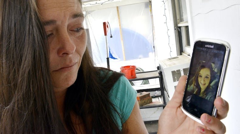 Becky Fent looks over a picture of her daughter, Clarissa Smith, who died in a car crash Sunday. Bill Lackey/Staff