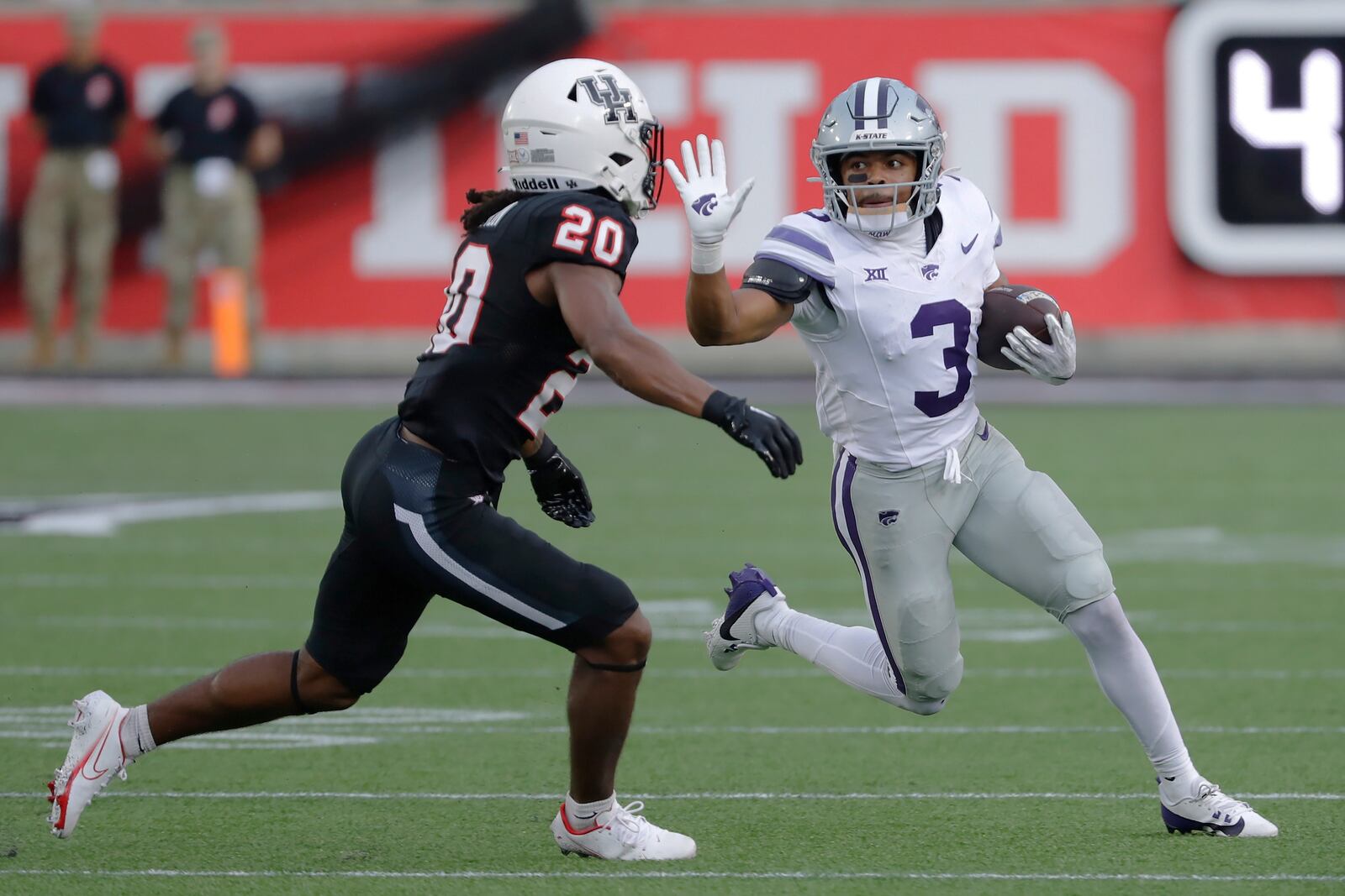 FILE - Kansas State running back Dylan Edwards (3) fends off Houston defensive back Jeremiah Wilson (20) on a gain during the first half of an NCAA college football game Saturday, Nov. 2, 2024, in Houston. (AP Photo/Michael Wyke, File)