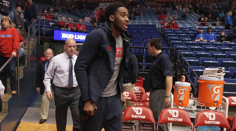 Josh Cunningham walks on crutches to the bench at UD Arena earlier this month. David Jablonski/Staff