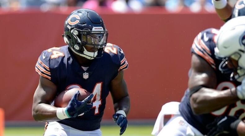 In this Sunday, Aug. 27, 2017 file photo, Chicago Bears running back Jordan Howard (24) runs the ball against the Tennessee Titans in the first half of an NFL football preseason game in Nashville, Tenn. Aaron Rodgers and the Green Bay Packers have regained their hold on the NFC North after a one-year lapse. The Minnesota Vikings, Detroit Lions and Chicago Bears will have to go through Lambeau Field once again if they're going to take the division. (AP Photo/Mark Zaleski, File)