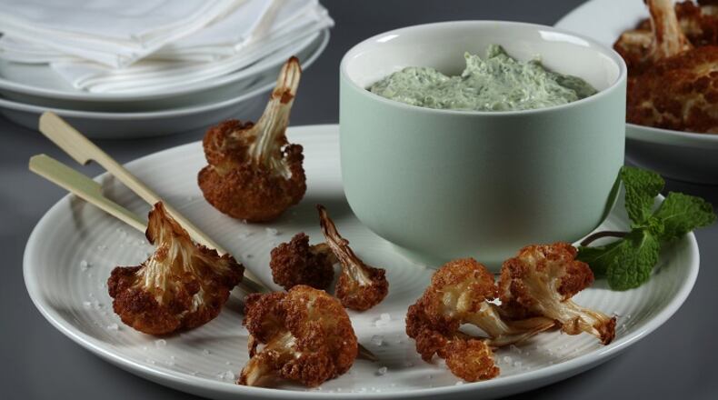 Fried cauliflower with labneh, adapted from the cookbook "Zahav: A World of Israeli Cooking" by Michael Solomonov and Steven Cook. (E. Jason Wambsgans/Chicago Tribune/TNS)