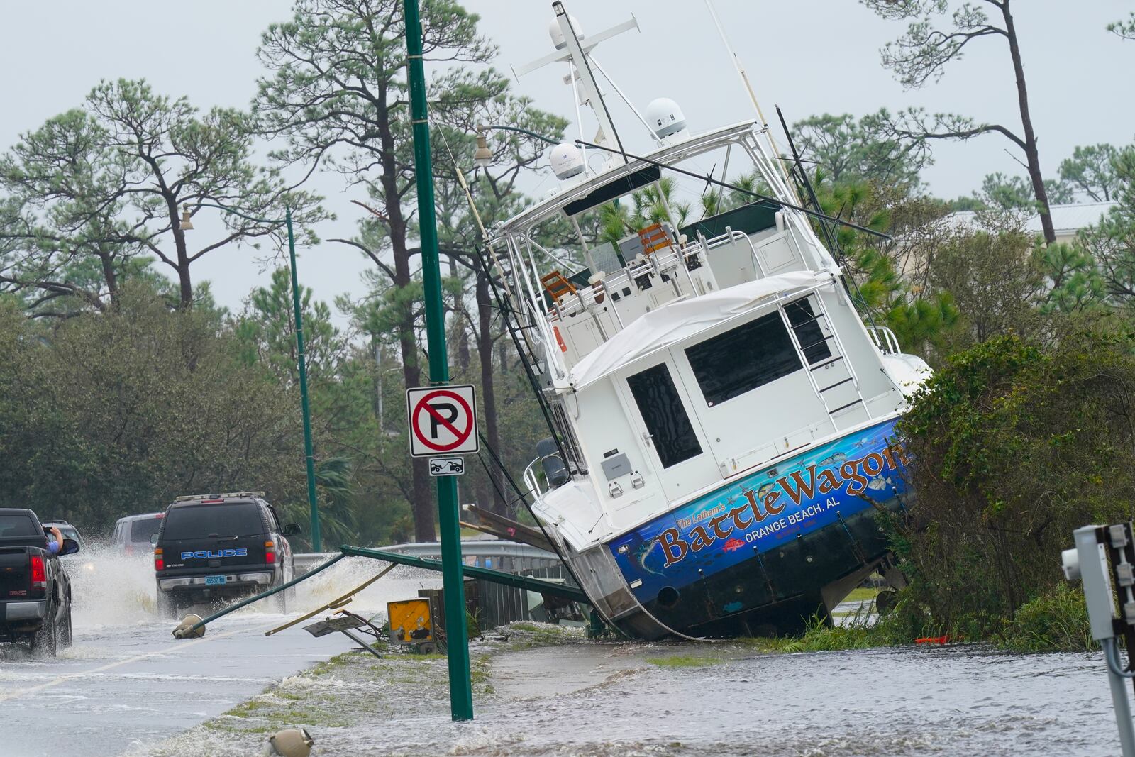 FILE - A boat is washed up near a road after Hurricane Sally moved through the area, Wednesday, Sept. 16, 2020, in Orange Beach, Ala. (AP Photo/Gerald Herbert, file)