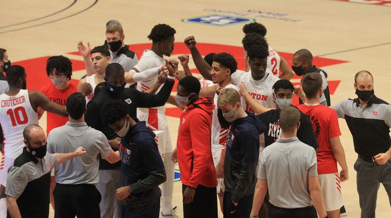 Dayton's Mustapha Amzil, Moulaye Sissoko, Jordy Tshimanga and Brett Comer huddle before a game against La Salle on Wednesday, Dec. 30, 2020, at UD Arena. David Jablonski/Staff