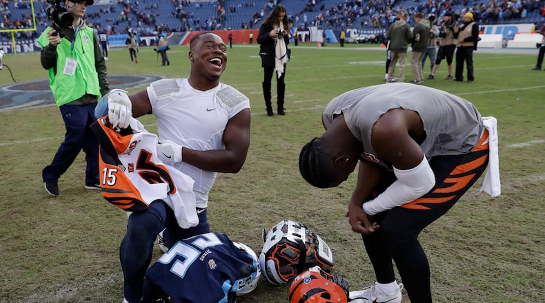 Tennessee Titans linebacker Jayon Brown, left, trades jerseys with Cincinnati Bengals wide receiver John Ross, right, after an NFL football game Sunday, Nov. 12, 2017, in Nashville, Tenn. The Titans won 24-20.(AP Photo/James Kenney)