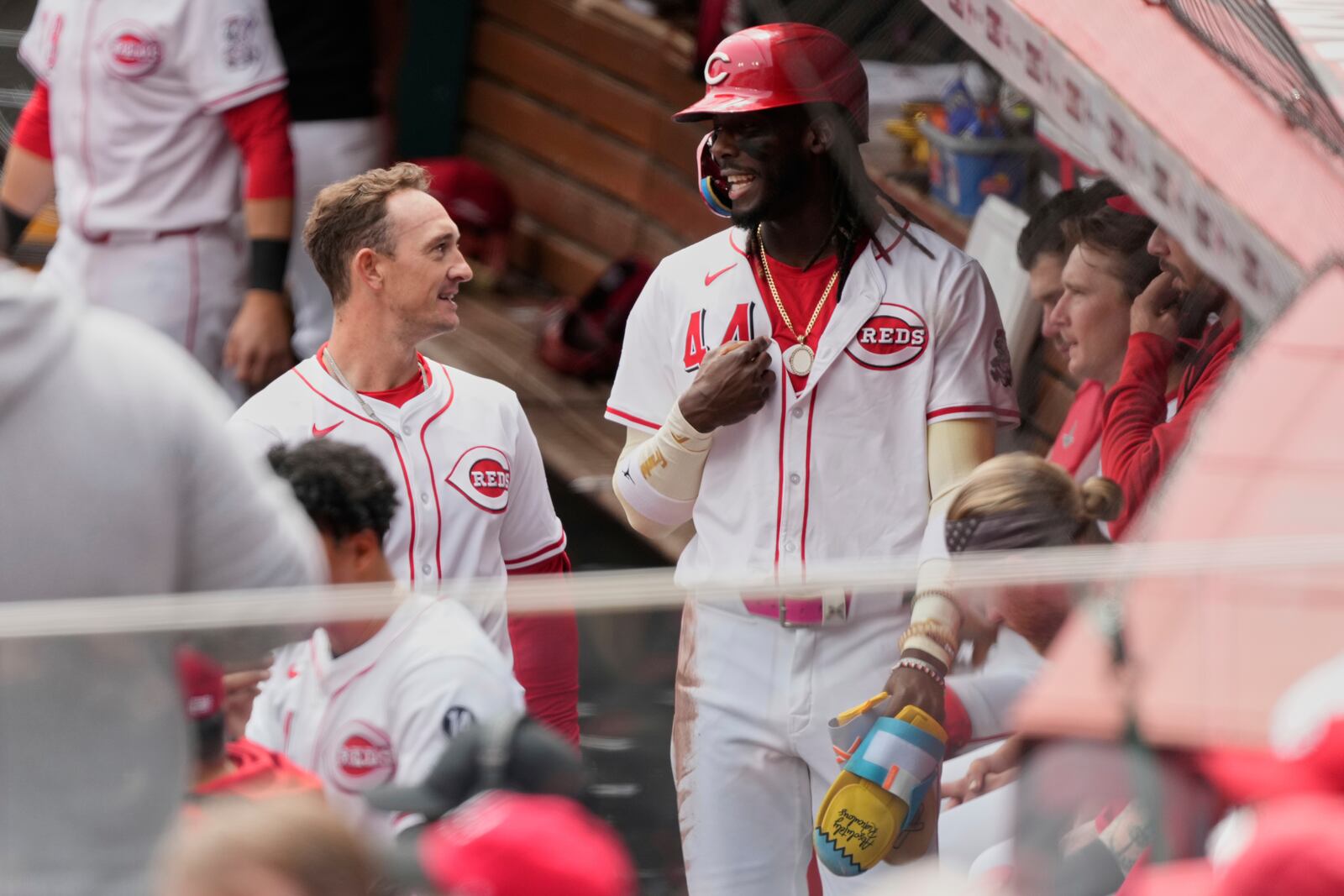 Cincinnati Reds Austin Hays, left, and Elly De La Cruz, right talk in the dugout after celebrating Hays' two-run homer in the first inning of a baseball game against the Seattle Mariners, Thursday, April 17, 2025, in Cincinnati. (AP Photo/Carolyn Kaster)