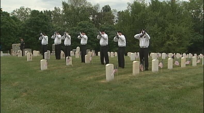 An honor squad conducts a 21-gun salute during Memorial Day services at Dayton National Cemetery. STAFF/ ERIC HIGGENBOTHAM