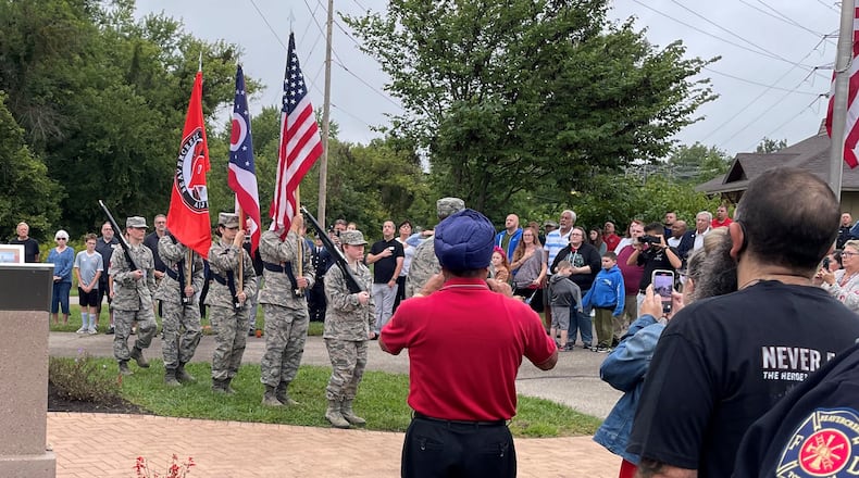 Military service members carried flags before the national anthem was played as more than 100 people who attended the 9/11 memorial event Sunday in Beavercreek. NICK BLIZZARD/STAFF