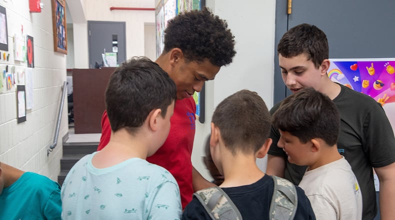 Julian Smith-Custer, Prairies Youth Center volunteer, shows children how to solve a Rubik’s Cube at the Prairies Youth Center on June 22. The PYC offers a wide variety of clubs and activities for youth ages 9 to 18. U.S. AIR FORCE PHOTO/AIRMAN 1ST CLASS JAMES JOHNSON