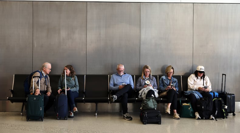 Travelers wait and check for their flights at San Francisco International Airport on Friday, Nov. 7, 2025. (Gabrielle Lurie /San Francisco Chronicle via AP)