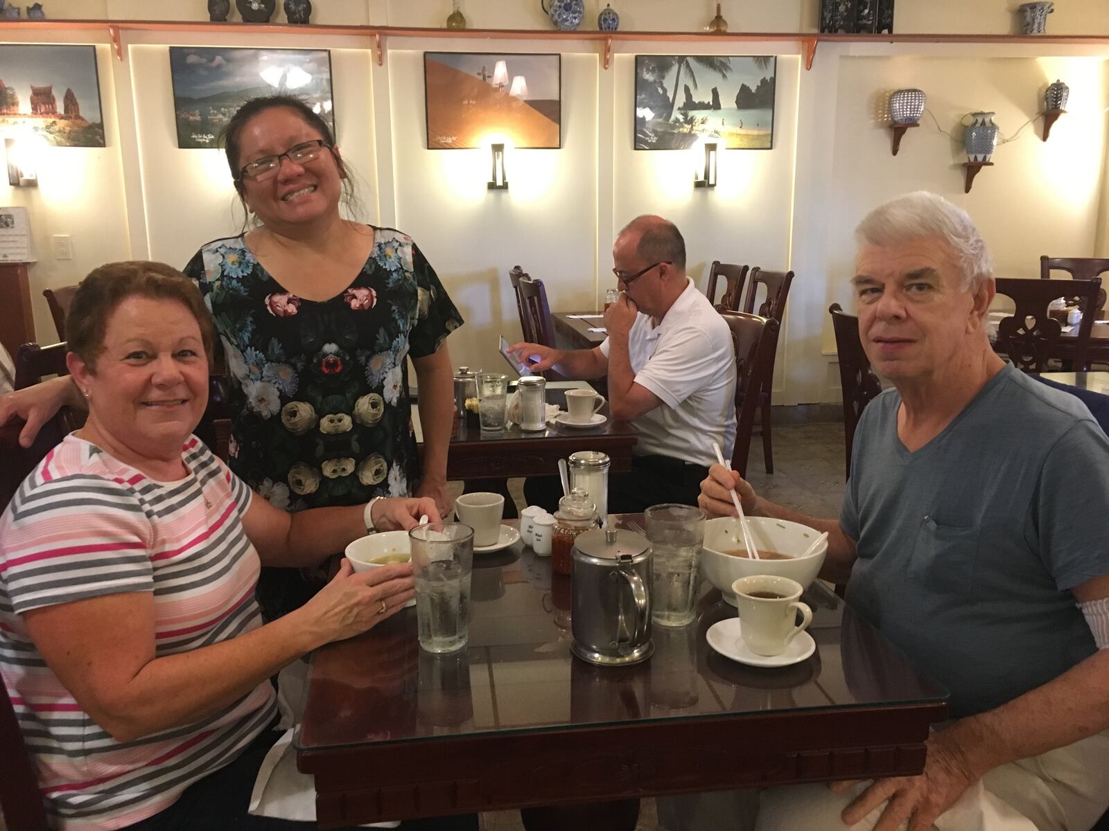 Little Saigon co-owner, Thauh Do “T.D.” Tran, visits with loyal customers.