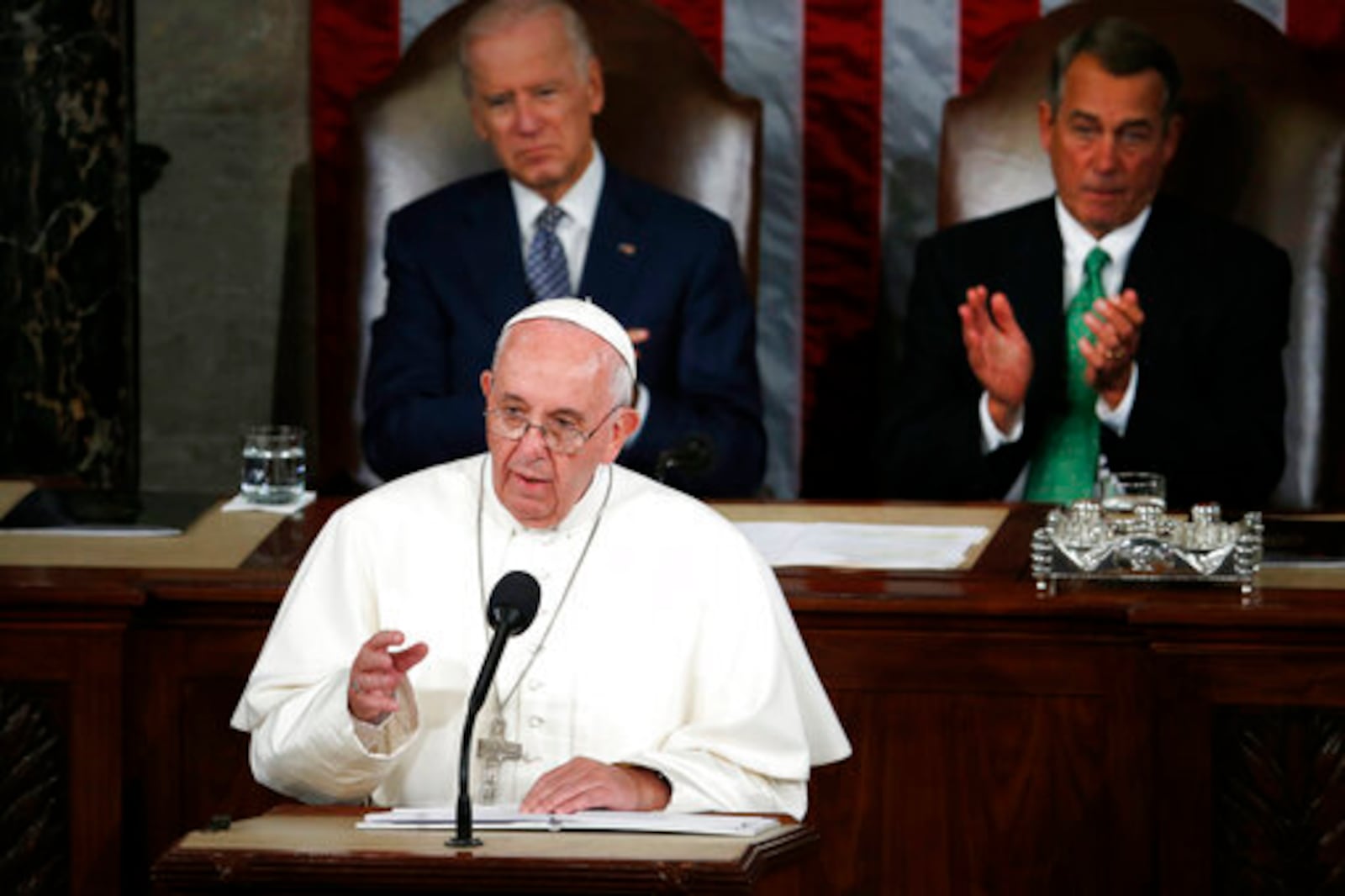 FILE - Pope Francis addresses a joint meeting of Congress on Capitol Hill in Washington, Thursday, Sept. 24, 2015. Listening behind the pope are then Vice President Joe Biden and House Speaker John Boehner of Ohio. (AP Photo/Carolyn Kaster, file)