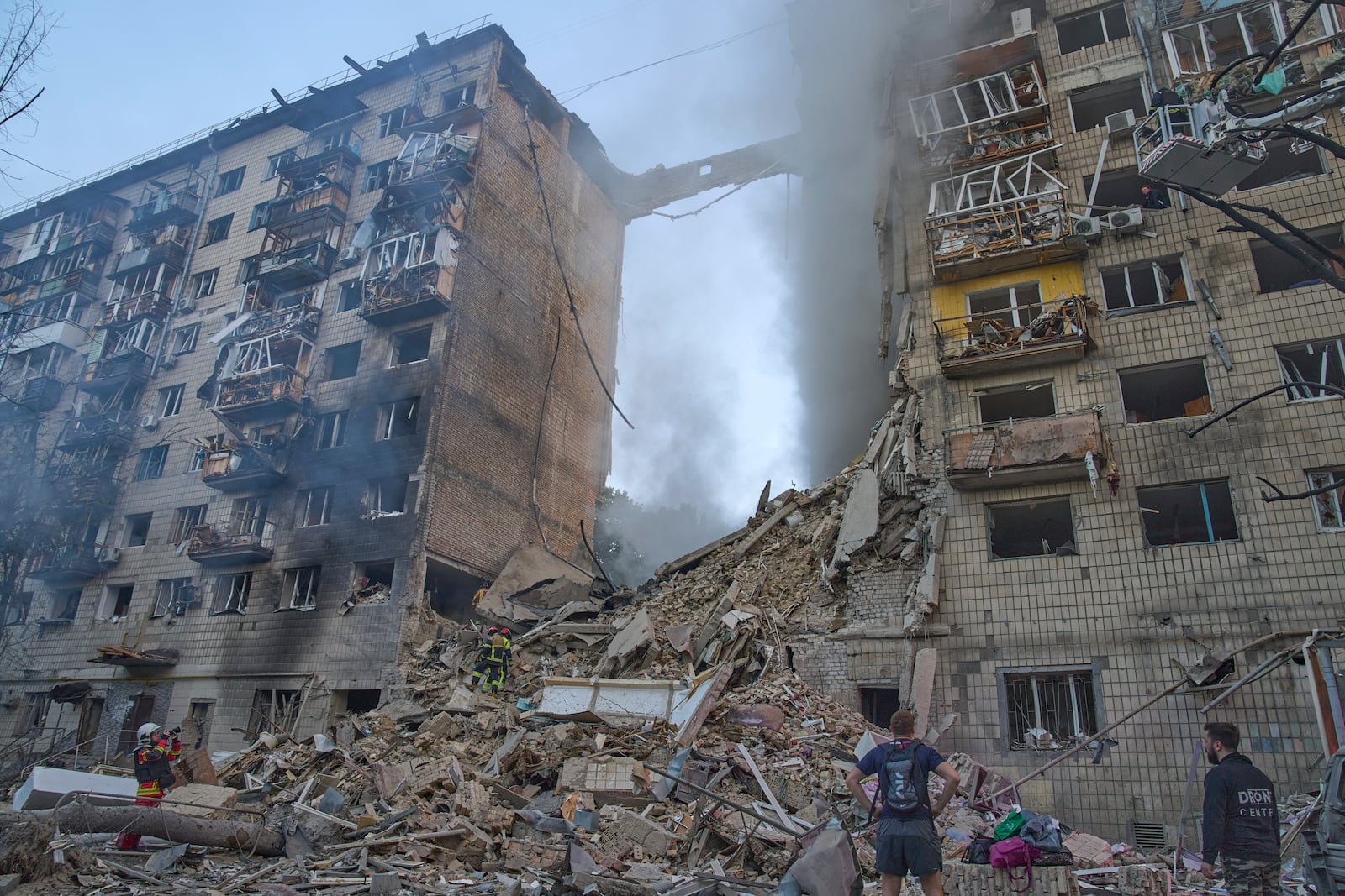 Firefighters put out the fire after a Russian missile hit a residential building during Russia's massive missile and drone air attack in Kyiv, Ukraine, Tuesday, June 17, 2025. (AP Photo/Efrem Lukatsky)