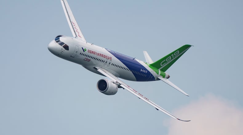 FILE - A COMAC C919 aircraft flies during the first day of the Singapore Airshow in Singapore, Feb. 20, 2024. (AP Photo/Vincent Thian, File)