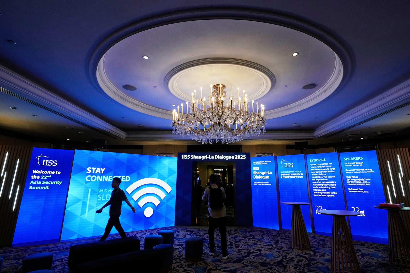 A worker walks inside a hall at the venue of 22nd Shangri-La Dialogue summit in Singapore, Thursday, May 29, 2025. (AP Photo/Anupam Nath)