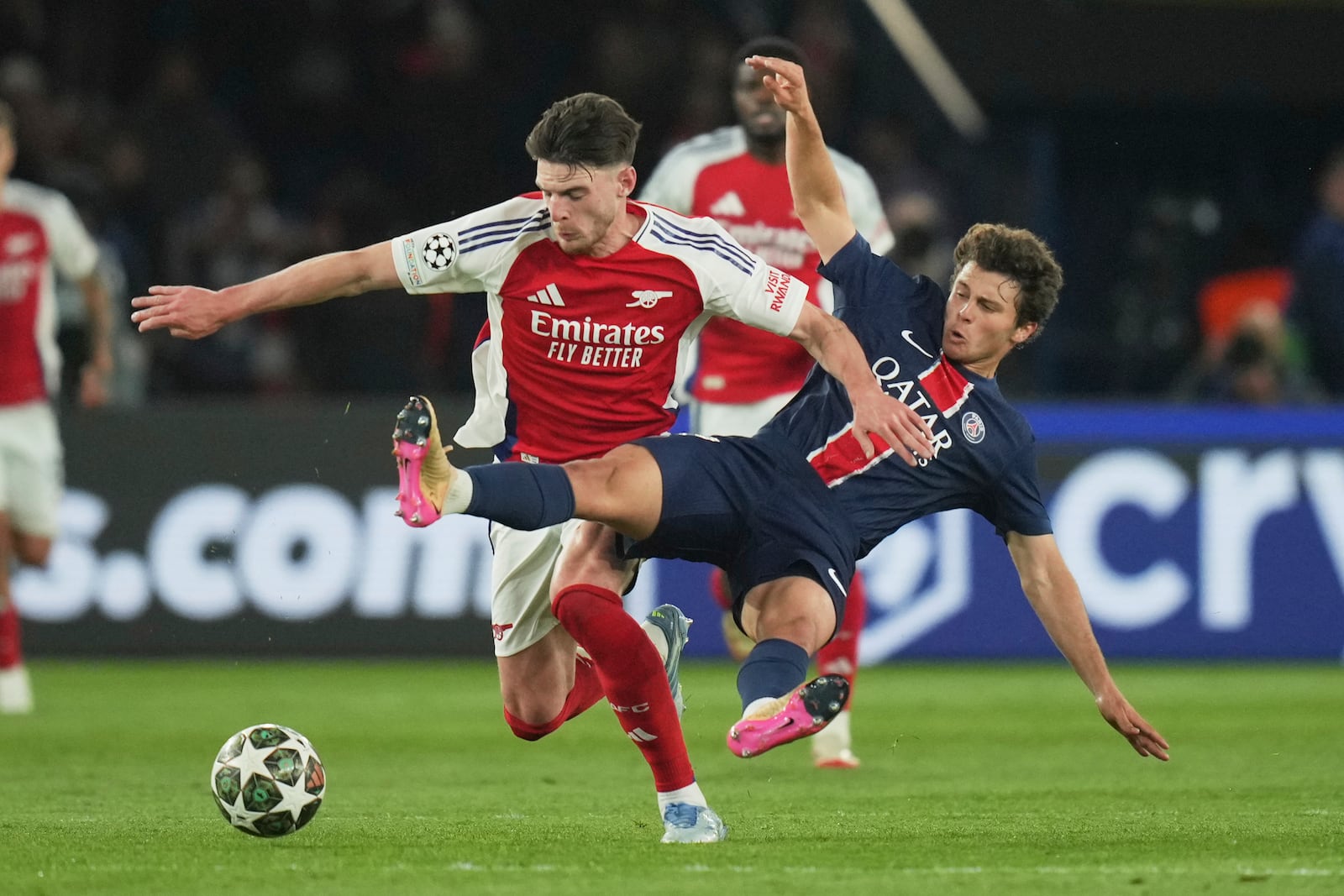 PSG's Joao Neves, right, challenges Arsenal's Declan Rice during the Champions League semifinal, second leg soccer match between Paris Saint-Germain and Arsenal at the Parc des Princes in Paris, Wednesday, May 7, 2025. (AP Photo/Thibault Camus)